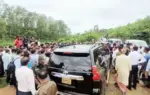 Car On Field People are Gathering