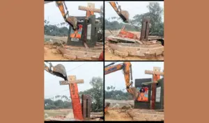 এক্সকাভেটর দিয়ে ভাস্কর্য অপসারণ করা হচ্ছে।