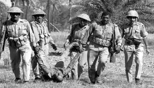 এক বাংলাদেশি লাশ টেনে নিয়ে যাচ্ছে পাকিস্তানি সেনারা।